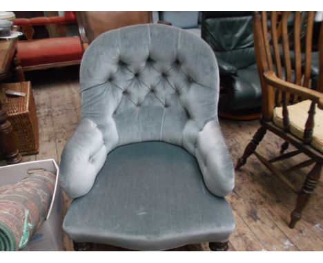 Victorian fireside armchair on reeded feet on castors, the button back arms and seat upholstered in light blue dralon