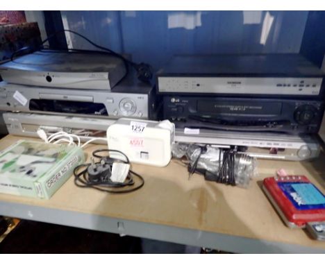 Shelf of mixed electricals to include VCR &amp; DVD players, Goodmans GDB2, Philips DVDR 70. Not available for in-house P&amp