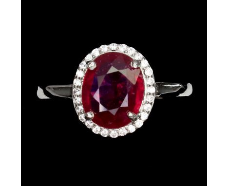 A 925 silver cluster ring set with an oval cut ruby surrounded by white stones, (P).