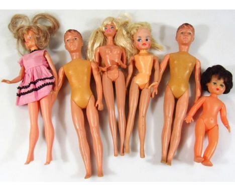 A 1966 copyright stamped Mattel Barbie doll, with articulated limbs and blonde hair, 29cm high, another similar male doll, a 
