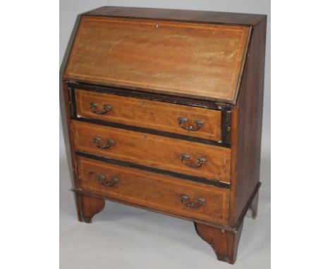 An Edwardian mahogany and boxwood strung bureau, the fall front with an outer cross banding and oval inlay, hinging to reveal