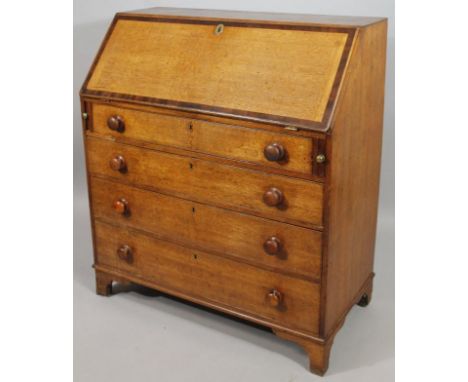 An 18thC oak bureau, the fall front with a wide mahogany crossbanding, hinging to reveal a fitted interior centred by a cupbo
