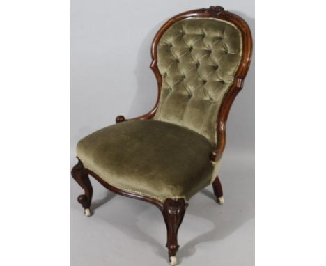 A late Victorian walnut spoon back open chair, in (later) button back green material with a shaped seat, above cabriole suppo