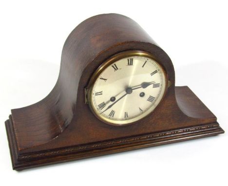 An early 20thC oak cased Napoleon hat mantel clock, with numeric dial revealing a key wind movement in a stepped case, 49cm w