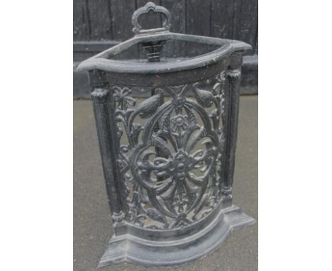 A late 19thC cast iron stick stand, in the manner of Coalbrookdale, with a moulded top handle above a shaped part pierced flo