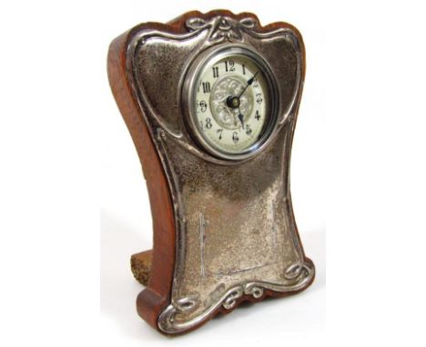 An Edwardian silver Art Nouveau design mantel clock, on an oak back, with fancy 5cm diameter Arabic dial, with United Clock m