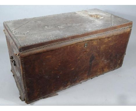 A pressed leather wooden bound travel trunk, of rectangular outline, with heavy metal handles and plain interior, 39cm high, 