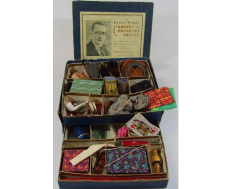 An early 20thC Ernest Sewell Cabinet of Conjuring Tricks child's magic set, the card packaging with lift off lid revealing a 