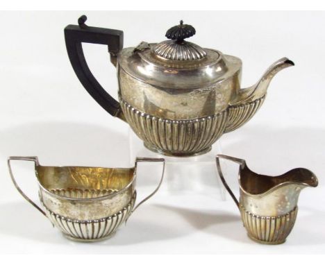 A matched late Victorian and Edwardian three piece bachelor's tea service, comprising teapot, with half ribbed body, angular 