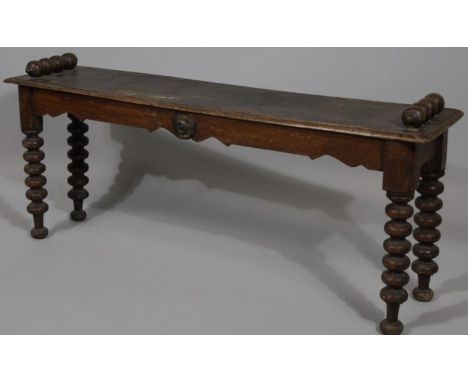 A 19thC mahogany window seat, of rectangular outline with bobbin turned side handles and supports on bun feet, 48cm high, 105