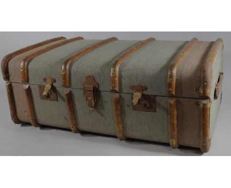 An early 20thC wooden bound domed top travel trunk, with a fitted interior and (removable) shelf, 34cm high, 86cm wide, 50cm 