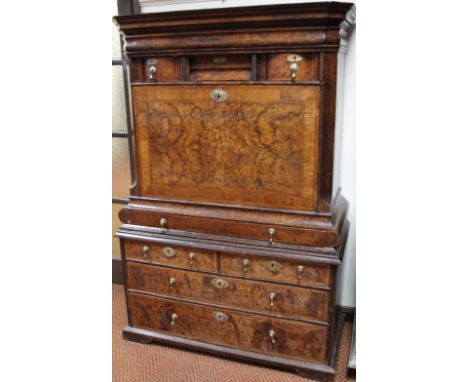 An 18thC walnut escritoire, the top with canted corners with a frieze drawer and arrangement of three smaller drawers, above 