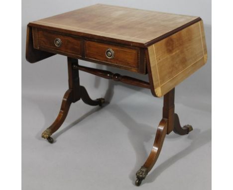 A Regency style mahogany sofa table, the rounded top with shell corners above frieze drawers on shaped sabre supports with br