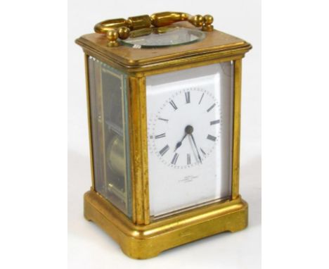 A late 19thC / early 20thC French brass carriage clock, in a five sided glass case, with swing handle and visible movement, t