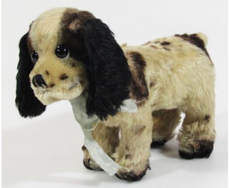 A 20thC plush jointed dog in the manner of Steiff, in standing pose, with growl action, unmarked, 18cm high. (AF)