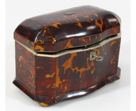 An early 19thC Regency tortoiseshell tea caddy, with serpentine front and hinged lid with (vacant) cartouche revealing a sect