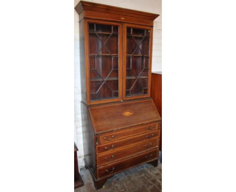 An Edwardian mahogany and boxwood strung bureau bookcase, the upper section with two astragal glazed doors revealing book she