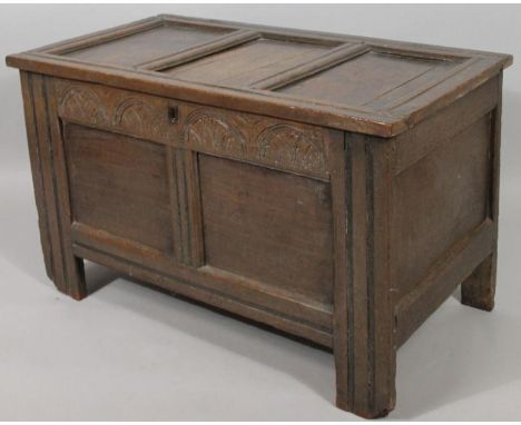 A late 17thC oak panel coffer, the rectangular lid hinging to reveal a plain interior on block supports, with a partially car