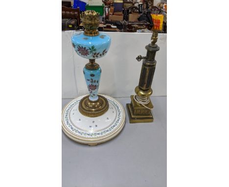 A Victorian brass oil lamp with turquoise painted glass, on a continental porcelain stand, together with one other, Location: