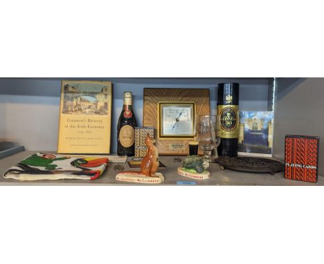 A collection of Guinness memorabilia to include Carlton ware model kangaroo and tortoise, barometer, playing cards, tea towel