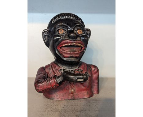 A vintage painted cast metal money box/bank in the form of an outdated depiction of an African GentlemanLocation: 6.1These it