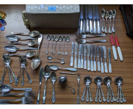 A selection of white metal and American sterling silver and silver plated flatware to include a sterling silver souvenir spoo