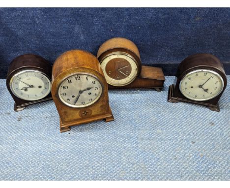 A group of four mantle clocks to include an Edwardian arch top 8 day mantle clock in a mahogany case, together with later Smi