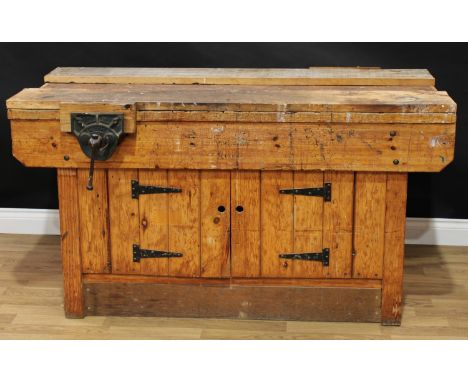 A pine workshop/work bench, each long side with a vice, the front with a pair of cupboard doors, 81.5cm high, 152.5cm wide, 7