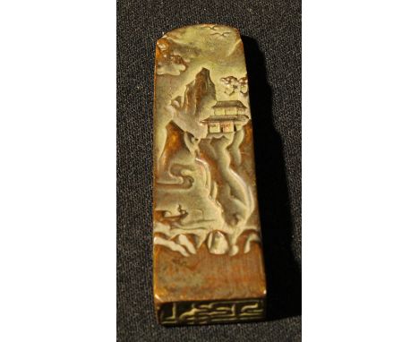 A Chinese bronzed metal scroll weight, 9.5cm long 