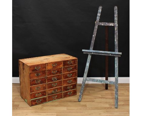 An artist or collector's chest of eighteen short drawers, 62.5cm high, 83cm wide, 41cm deep; an easel, 144cm high, 59cm wide 