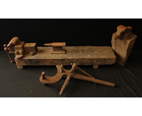 A Handy O bench vice; another bench vice mounted with a small anvil; other cast tool. (3)Provenance: Estate of Thomas Jones, 
