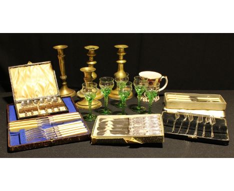 A set of six silver hafted butter knives, Sheffield 1922; other cased flatware; brass candlesticks, etc 