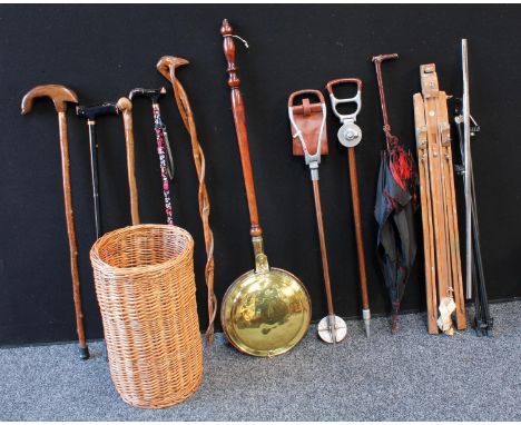 A wicker stick stand, walking sticks, shooting sticks, parasol, copper warming pan; etc 