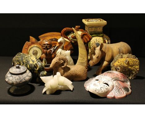 A soapstone model of a rhino; a carved wooden rhino; a ceramic elephant stand; a Venetian mask; a horseshoe barometer; a fish