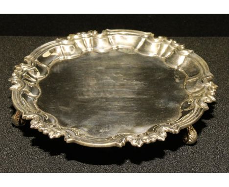 A George V silver shaped circular card waiter, of plain George III design, 15.5cm diam, William Hutton &amp; Sons Ltd, Sheffi