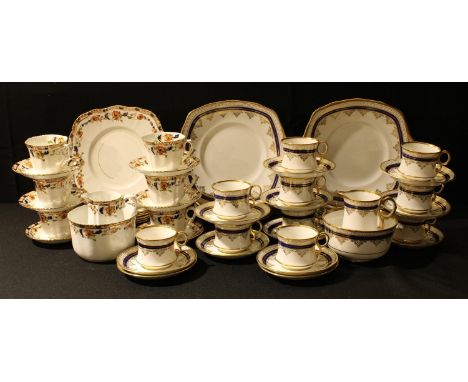 A Royal Albert Crown China part tea set, applied with bands of cobalt blue and gold, comprising tea cups, saucers, tea plates