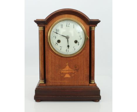 An Edwardian mahogany and marquetry eight-day mantel clock - circa 1910, the arched mahogany case with covered tazza marquetr