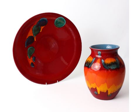 Two pieces of modern Poole Pottery - comprising a large Odyssey charger, glazed in deep red with orange, turquoise and blue s