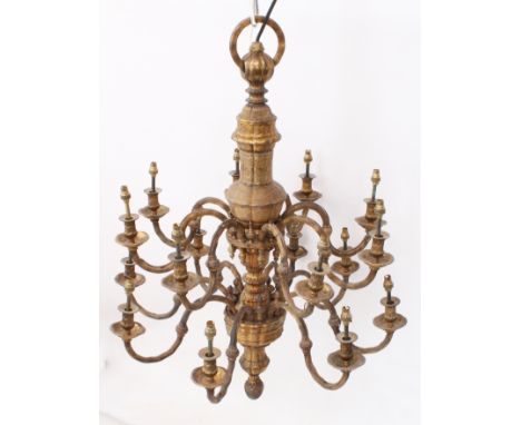 An impressive early 20th century sixteen-light gilt two-tier brass chandelier - the sixteen reeded, ball-knopped scroll arms 