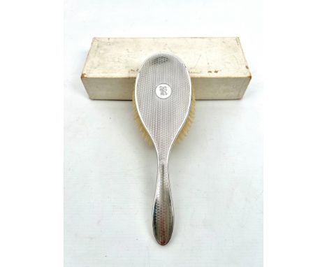 A boxed George V silver hair brush - Daniel Manufacturing Co., Birmingham 1930, engine turned decoration, with engraved initi