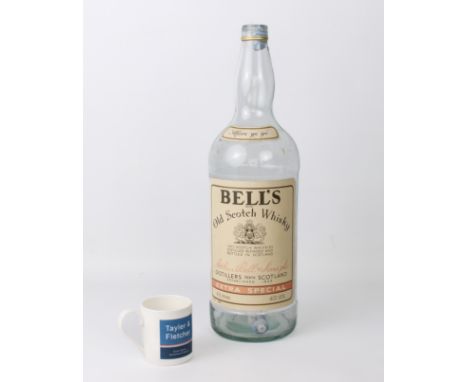 An oversized 4.5 litre Bells Extra Special Old Scotch Whiskey bottle - empty, no cap, some fading to label.