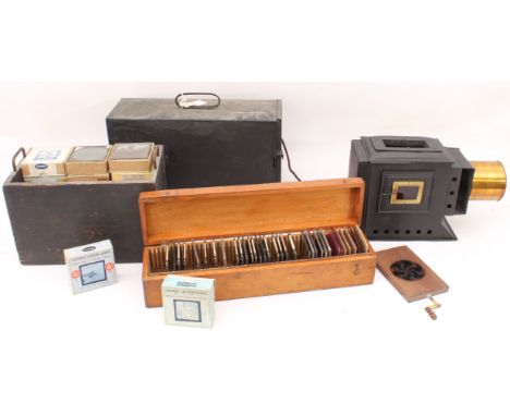 A cased magic lantern and a good quantity of slides to include: a mahogany and gilt-brass hand-cranked rotary Kaleidoscope sl