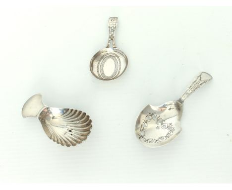 Three hallmarked silver George III caddy spoons.* Condition: The circular bowl spoon by William Pinder has a soldered repair 
