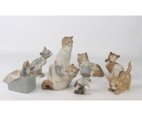 Seven porcelain figures of cats and Kittens by Lladro and Nao - the largest 17.8 cm high; together with a pale tan figure of 