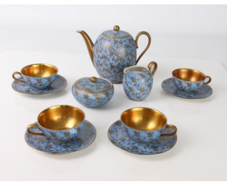 A German porcelain coffee set by Rhenania of Duisdorf - 1920s-30s, decorated with overall gilt floral decoration on a light b