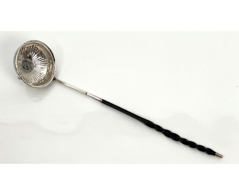 A Georgian white metal toddy ladle - unmarked, the circular bowl with repouss&eacute; flowerhead decoration around a central 