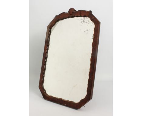 A 1930s octagonal walnut easel back mirror - the frame with serpentine sight edge and shell cresting, 55 x 35.25 cm.