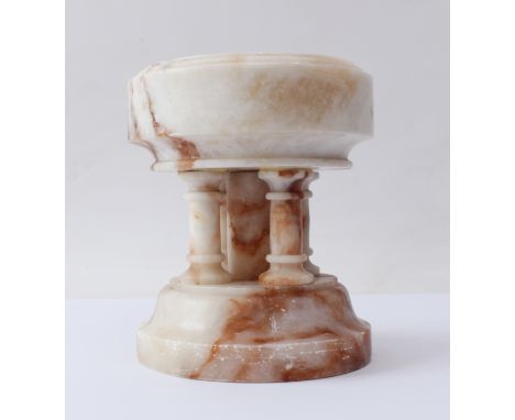 A carved alabaster font - probably first half 20th century, the circular bowl supported on five columns to an ogee moulded so