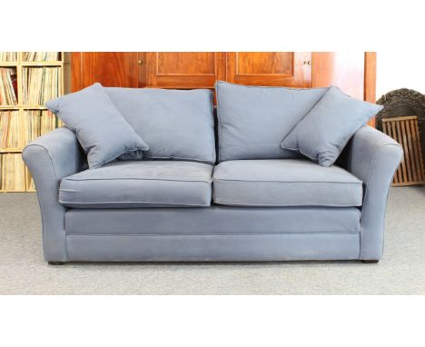 A Barker and Stonehouse 'Berkeley' three-seater sofa - circa 2022, in plain blue upholstery, on short, square ebonised feet (