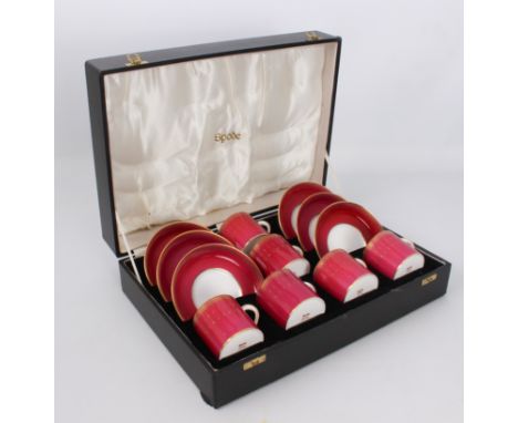 A cased set of six Spode bone china&nbsp;coffee cans and saucers - 1970s-80s, decorated with gilt pendant borders on a cerise